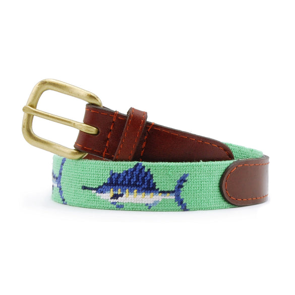 Children’s belt coiled with the stitched billfish design on a mint needlepoint background, finished with brown leather and a brass buckle.