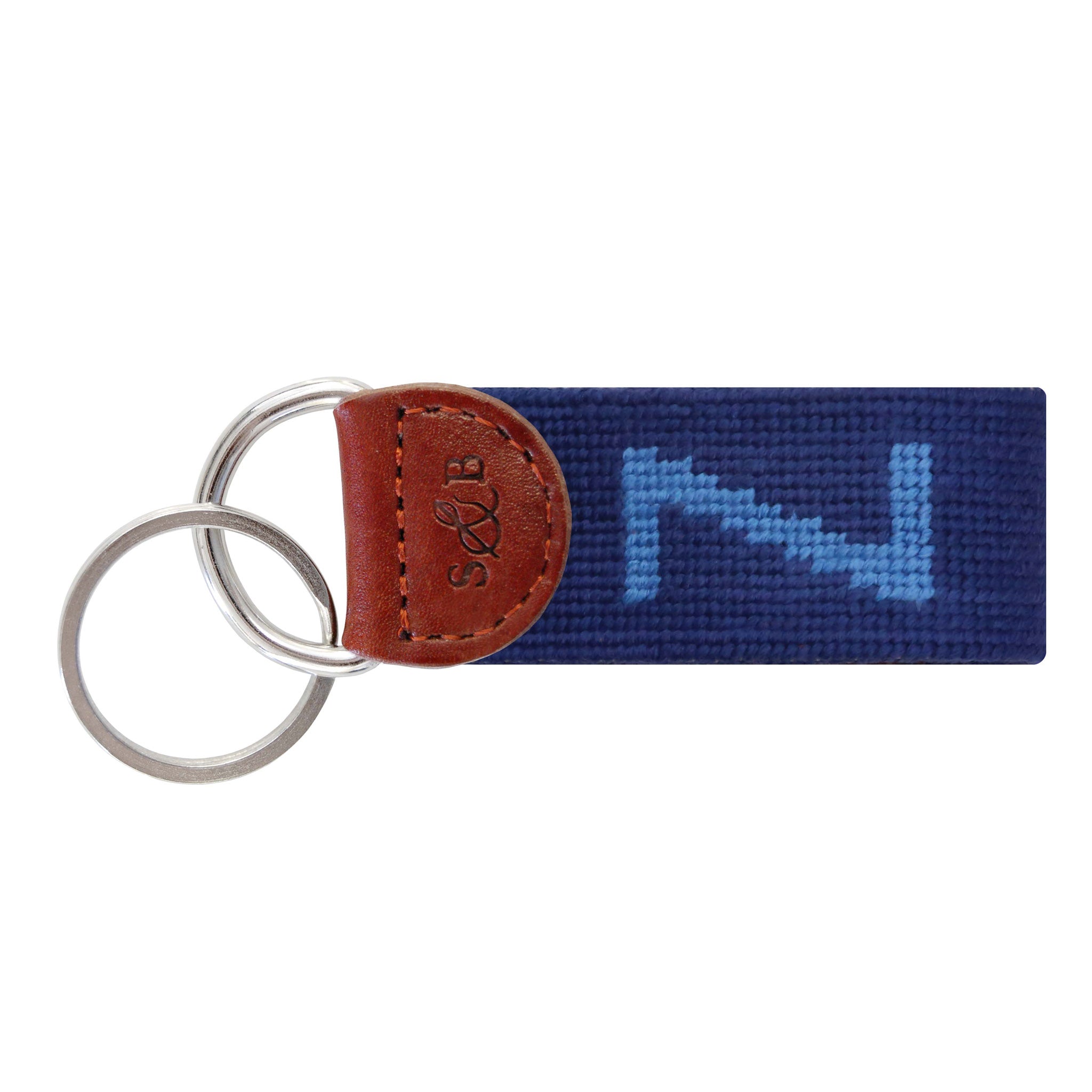 Navy needlepoint key fob featuring a white block letter “Z,” brown leather trim, and a metal key ring.