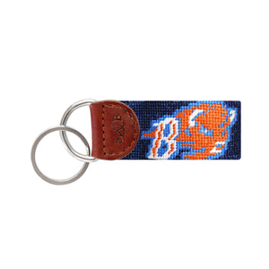 Navy needlepoint key fob featuring the orange Bucknell bison logo, brown leather trim, and a metal key ring.