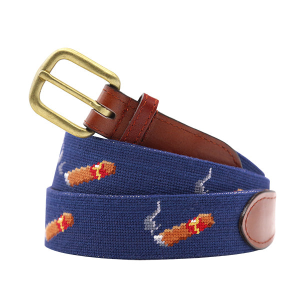 Blue needlepoint cigar belt with brown leather strap and brass buckle on a white background