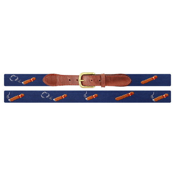Blue needlepoint cigar belt with brown leather strap and brass buckle on a white background