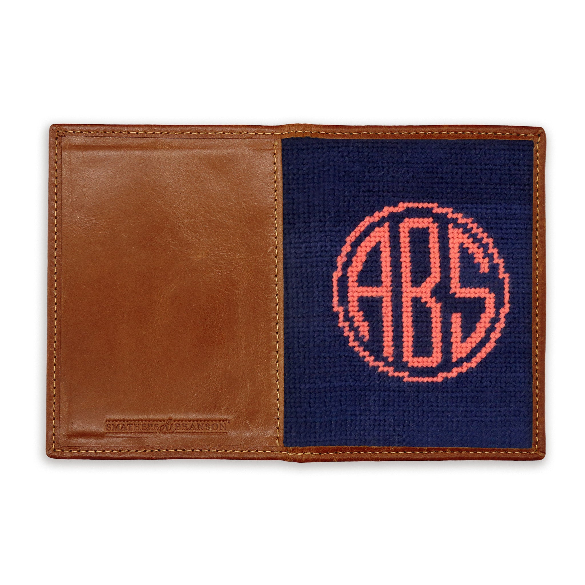 Back view of the circle monogram needlepoint passport case showing leather texture and stitching