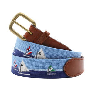 Day Sailor Needlepoint Belt coiled, with brown leather trim and a brass buckle
