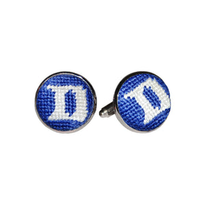 Duke cufflinks featuring the blue and white collegiate logo stitched in needlepoint, set into a silver-plated cufflink.