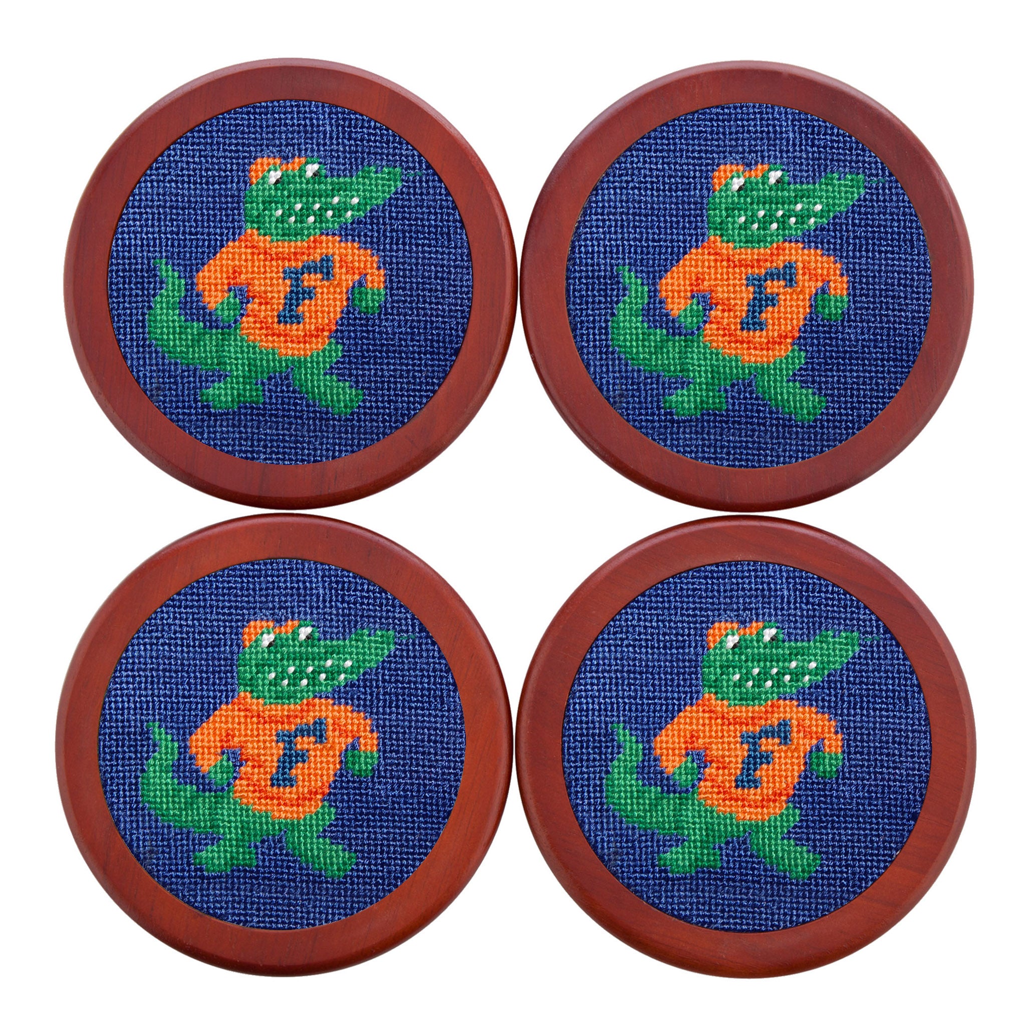 Royal blue needlepoint coaster set with orange “F” logos and Florida Gators colors, finished with chestnut wood backing.