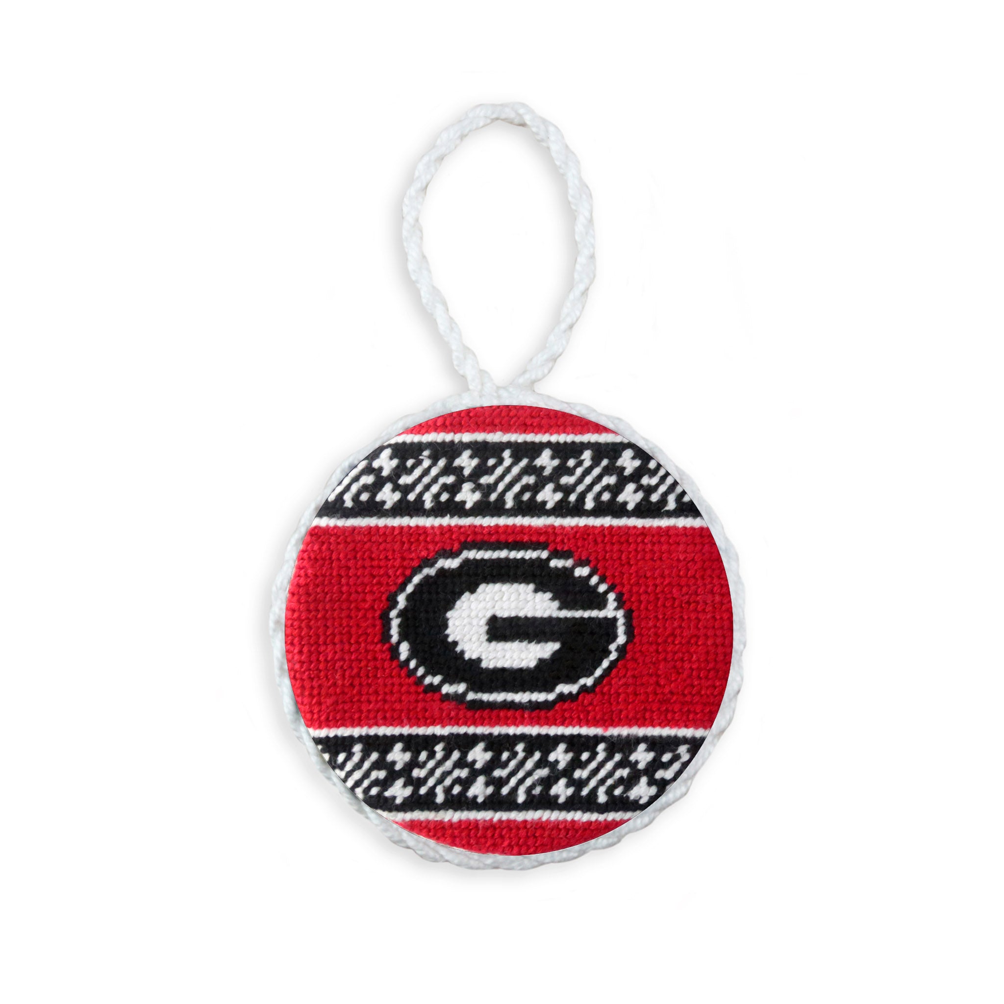 Red needlepoint ornament with a white fair isle pattern and the Georgia “G” logo, finished with a white hanging cord.