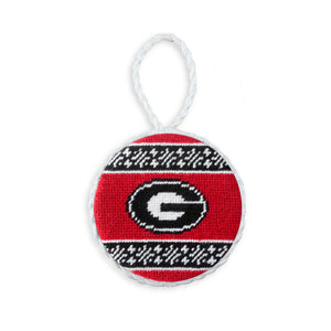Red needlepoint ornament with a white fair isle pattern and the Georgia “G” logo, finished with a white hanging cord.