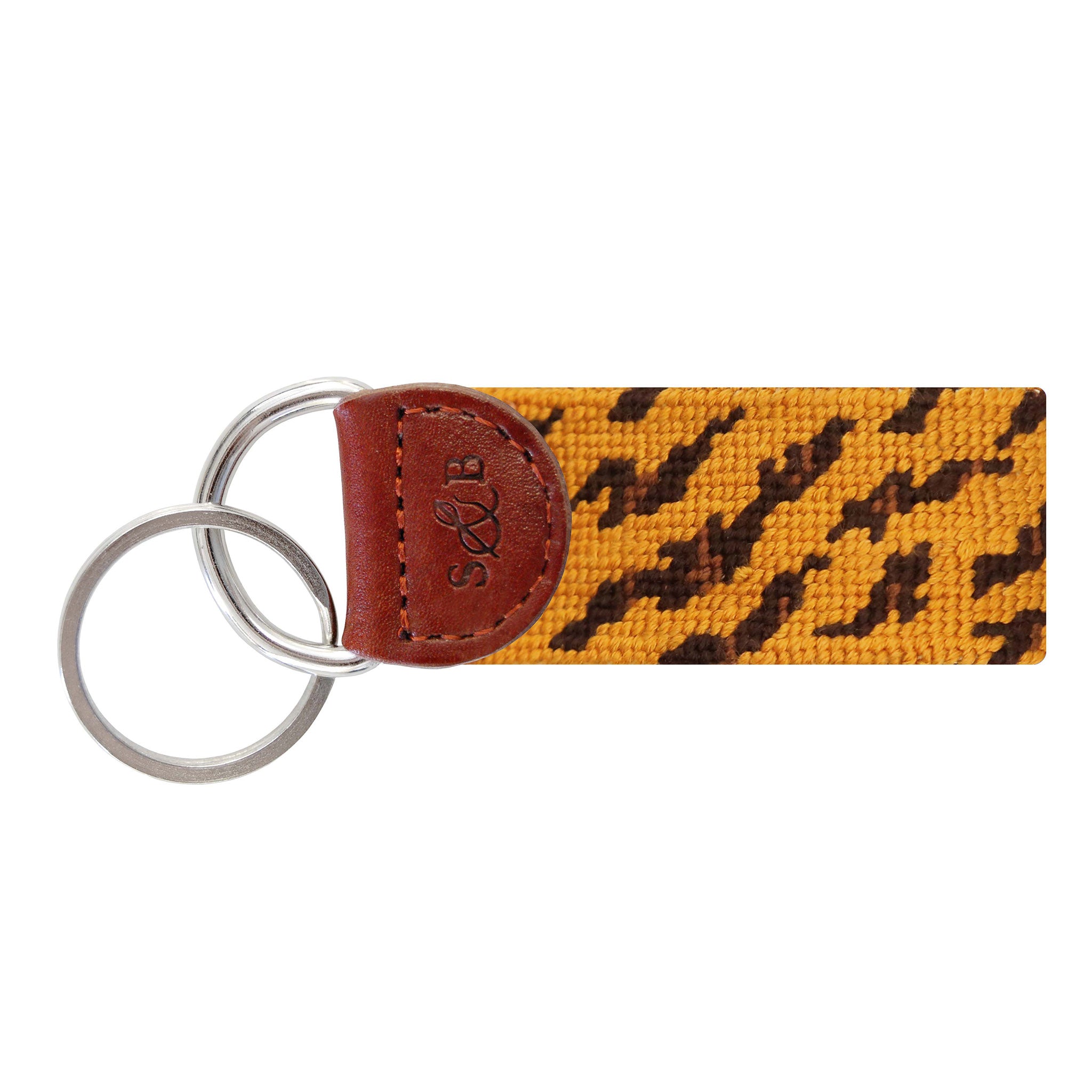 Purple and gold needlepoint key fob with a bold tiger stripe pattern, brown leather trim, and a metal key ring.