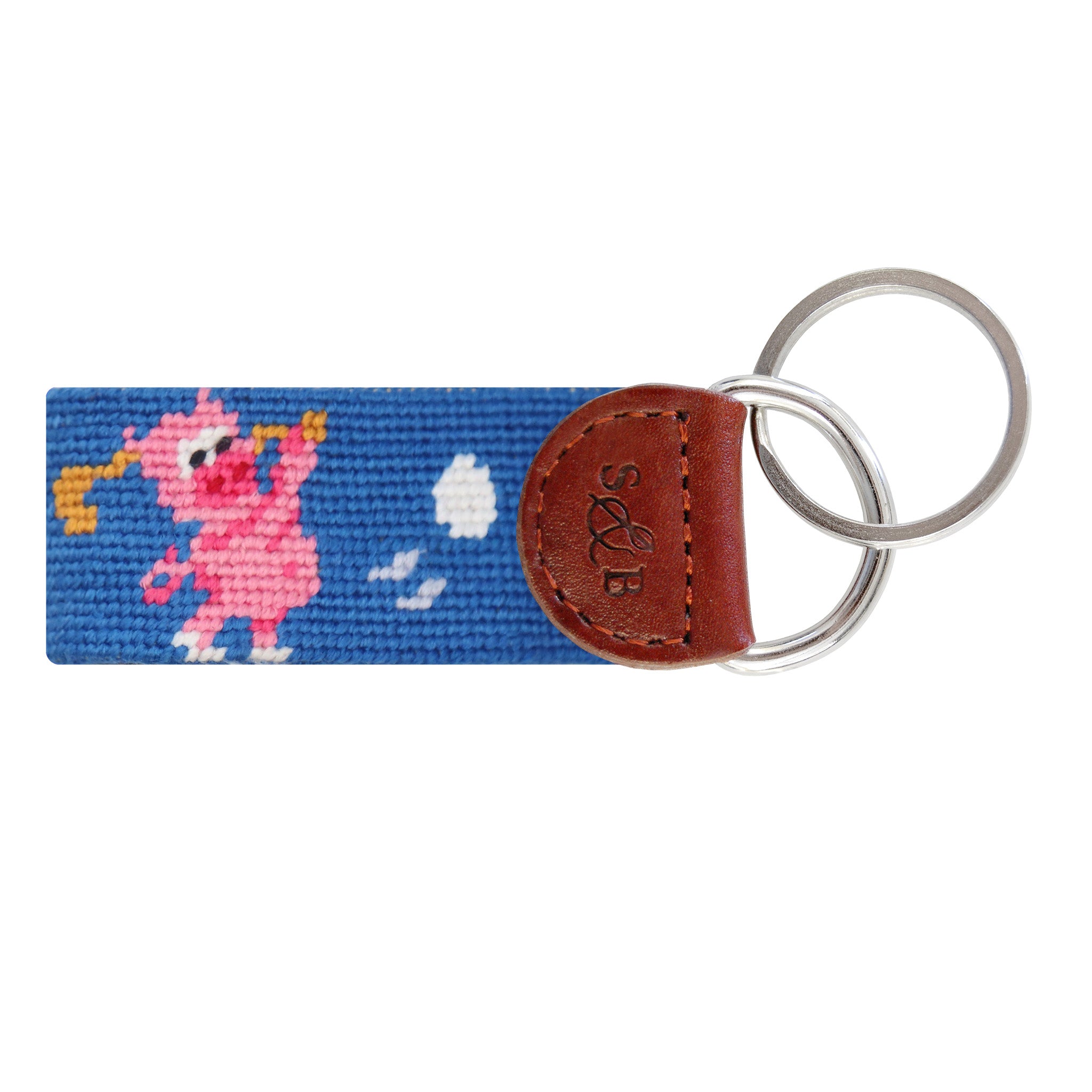 Blue needlepoint key fob featuring a repeating fried egg and ham pattern, brown leather trim, and a metal key ring.
