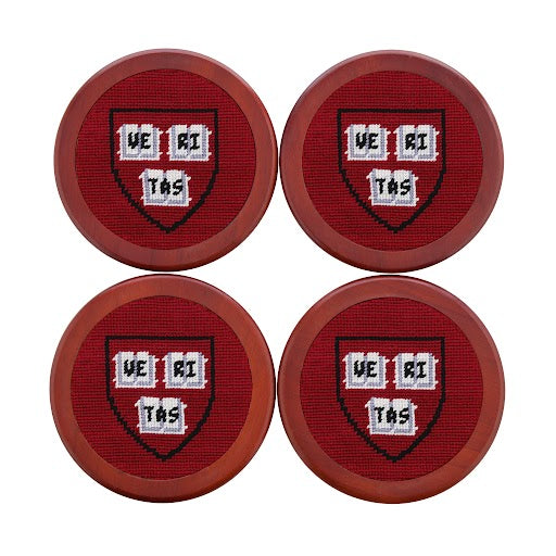 Coaster set featuring the Harvard collegiate shield stitched in crimson and white on a dark background, shown laid flat.