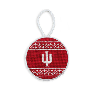 Crimson needlepoint ornament with the white Indiana “IU” logo, finished with a white hanging cord.