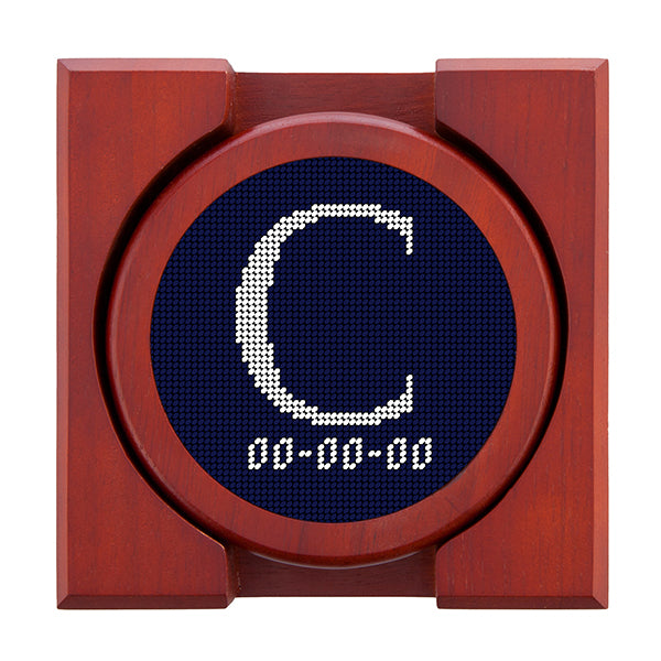 Dark Navy needlepoint coaster set featuring a white large embroidered letter above a custom date, framed with chestnut wood
