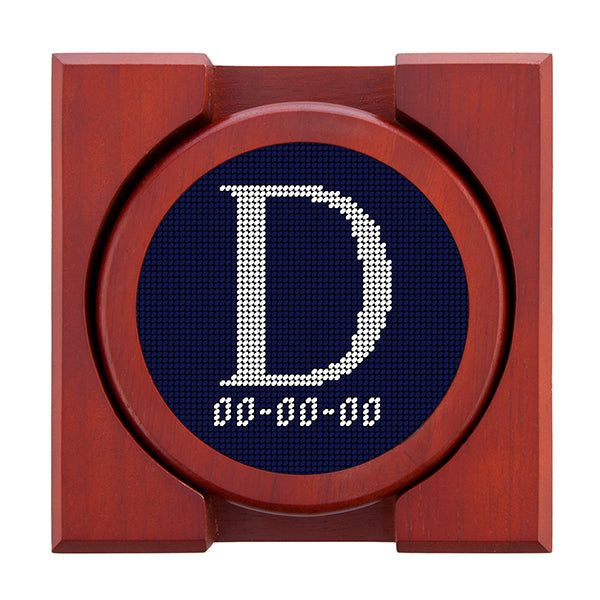 Dark Navy needlepoint coaster set featuring a white large embroidered letter above a custom date, framed with chestnut wood