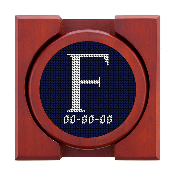 Dark Navy needlepoint coaster set featuring a white large embroidered letter above a custom date, framed with chestnut wood