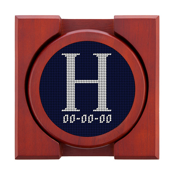 Dark Navy needlepoint coaster set featuring a white large embroidered letter above a custom date, framed with chestnut wood