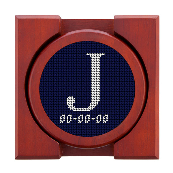 Dark Navy needlepoint coaster set featuring a white large embroidered letter above a custom date, framed with chestnut wood