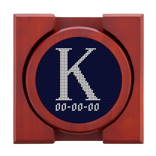 Dark Navy needlepoint coaster set featuring a white large embroidered letter above a custom date, framed with chestnut wood