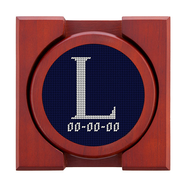 Dark Navy needlepoint coaster set featuring a white large embroidered letter above a custom date, framed with chestnut wood