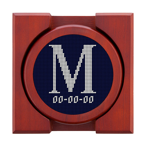 Dark Navy needlepoint coaster set featuring a white large embroidered letter above a custom date, framed with chestnut wood