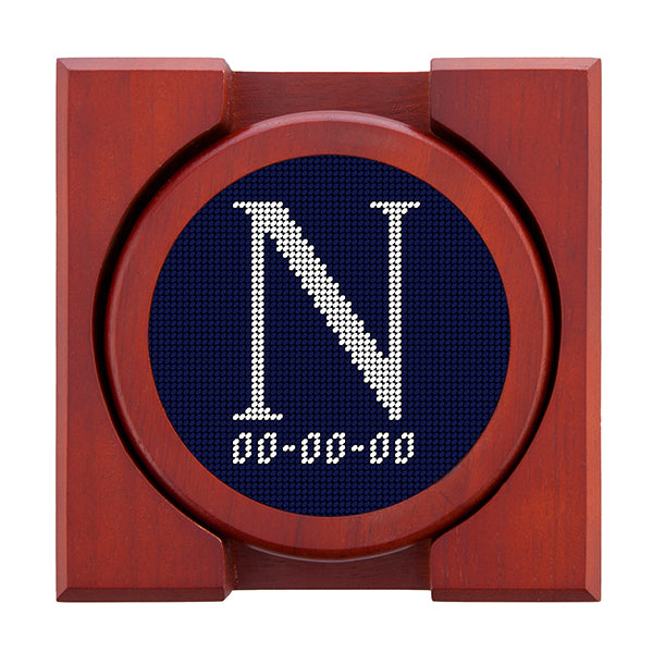 Dark Navy needlepoint coaster set featuring a white large embroidered letter above a custom date, framed with chestnut wood