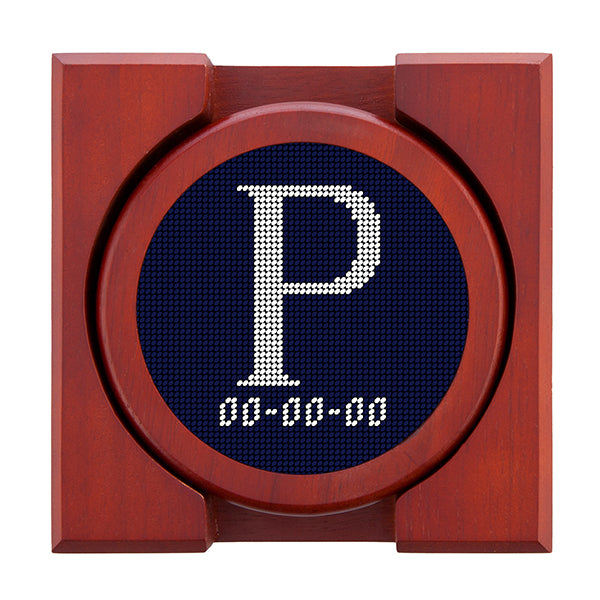 Dark Navy needlepoint coaster set featuring a white large embroidered letter above a custom date, framed with chestnut wood
