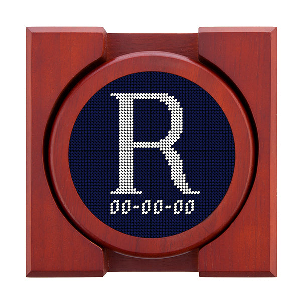 Dark Navy needlepoint coaster set featuring a white large embroidered letter above a custom date, framed with chestnut wood