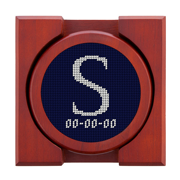 Dark Navy needlepoint coaster set featuring a white large embroidered letter above a custom date, framed with chestnut wood