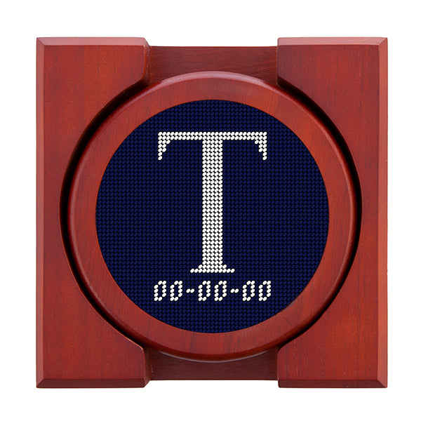 Dark Navy needlepoint coaster set featuring a white large embroidered letter above a custom date, framed with chestnut wood