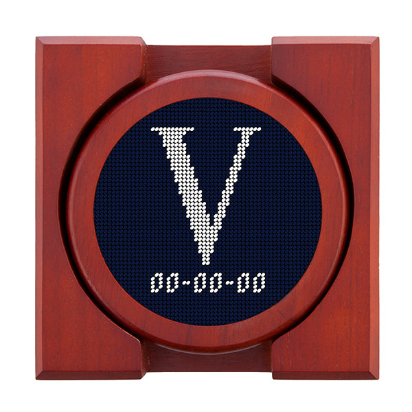 Dark Navy needlepoint coaster set featuring a white large embroidered letter above a custom date, framed with chestnut wood