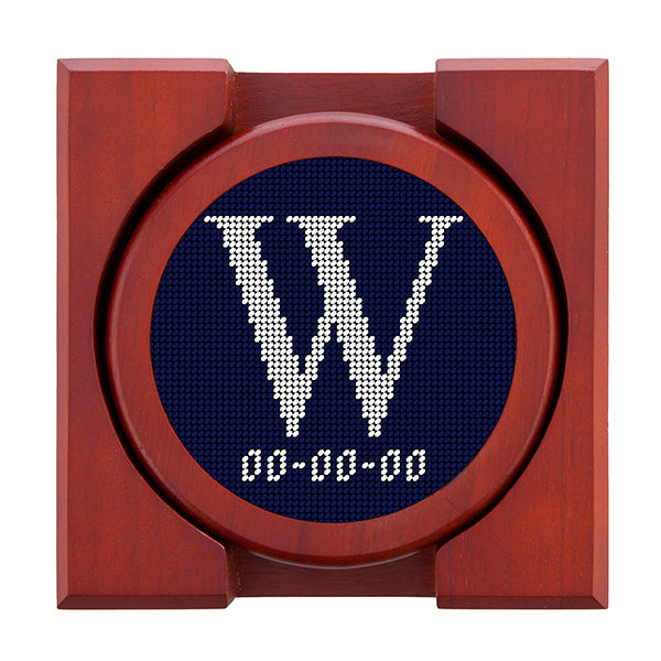 Dark Navy needlepoint coaster set featuring a white large embroidered letter above a custom date, framed with chestnut wood