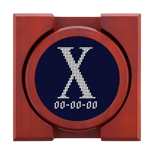 Dark Navy needlepoint coaster set featuring a white large embroidered letter above a custom date, framed with chestnut wood