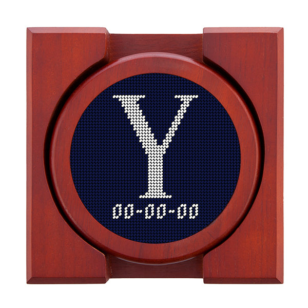 Dark Navy needlepoint coaster set featuring a white large embroidered letter above a custom date, framed with chestnut wood