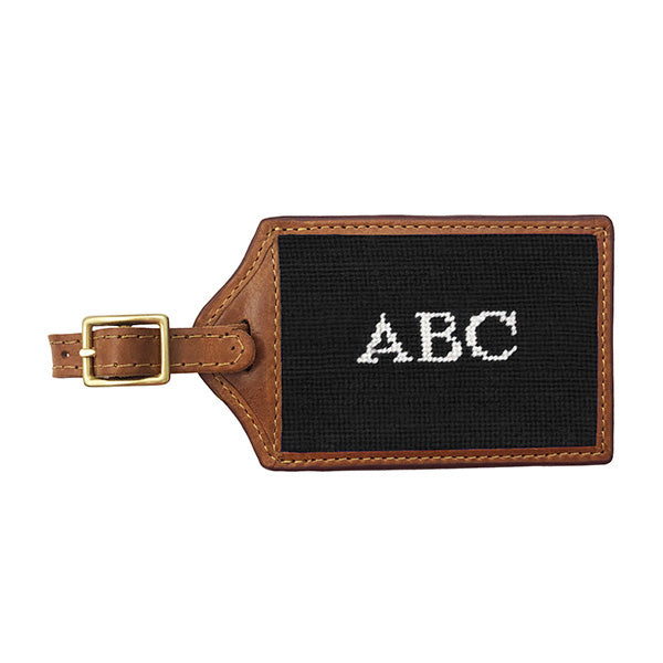 Hunter green needlepoint luggage tag with white Block 10 monogram initials, brown leather trim, and an ID window on the back.