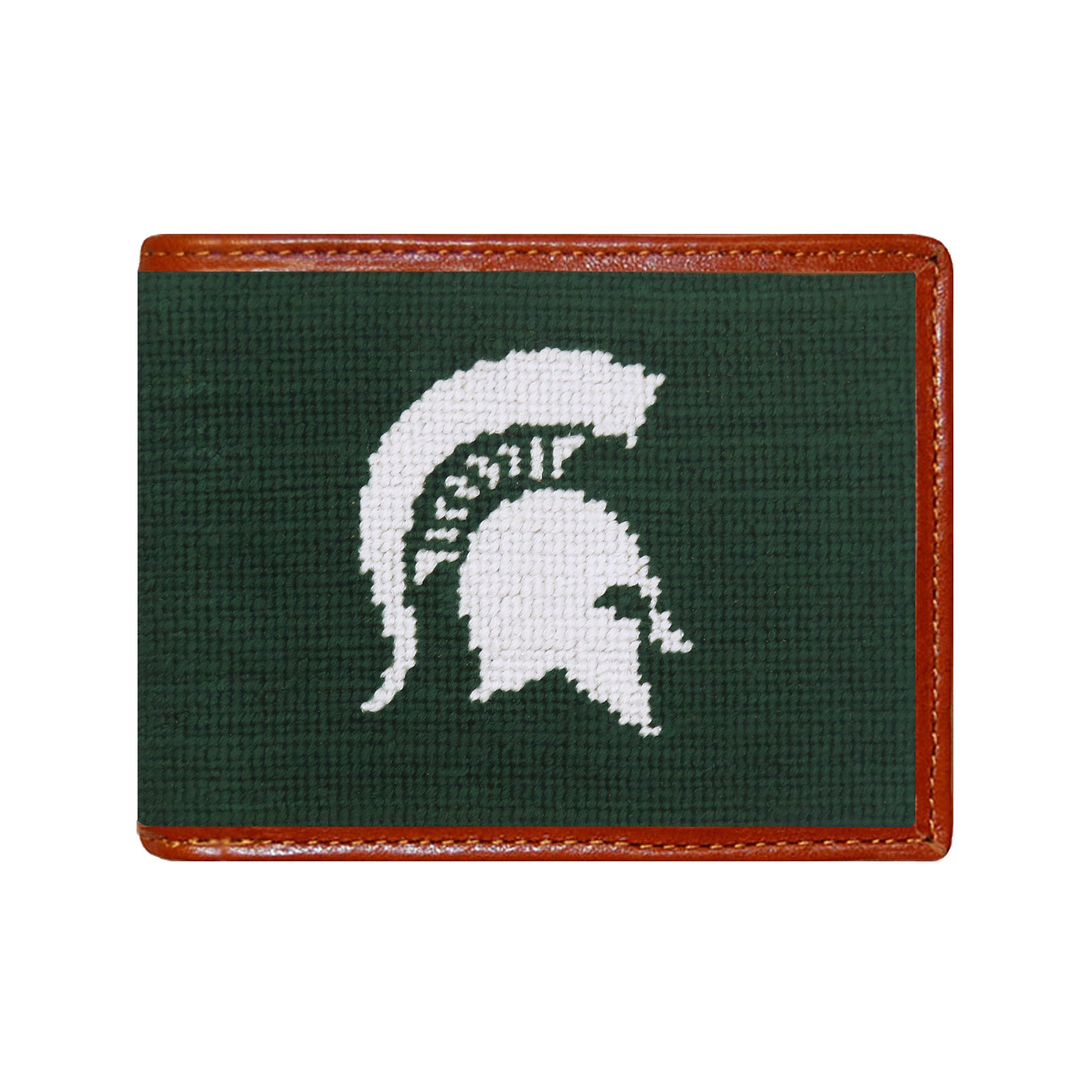 Michigan State Spartan needlepoint bi-fold wallet in dark pine with chestnut leather trim, shown from primary angle.