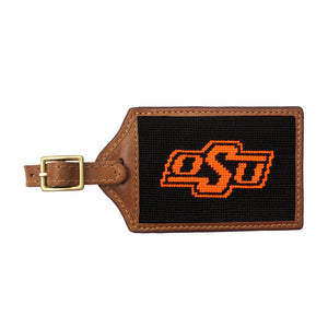 Orange needlepoint luggage tag featuring the white Oklahoma State “OSU” logo, brown leather trim, and an ID window on the back.