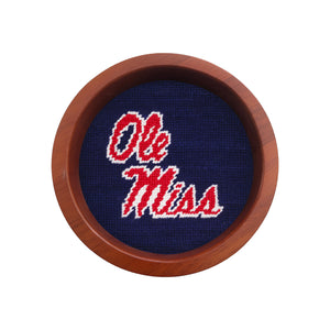 Round wooden wine bottle coaster featuring the Ole Miss logo stitched in needlepoint.