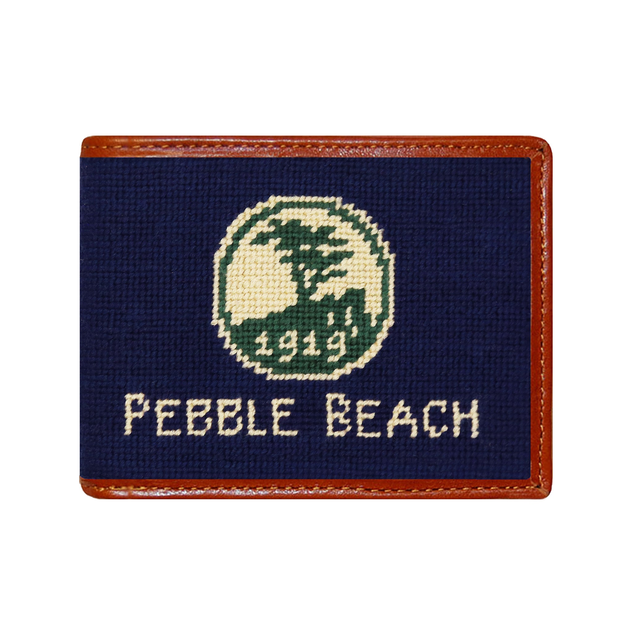 Pebble Beach logo needlepoint bi-fold wallet in dark navy with chestnut leather trim, shown from primary angle.