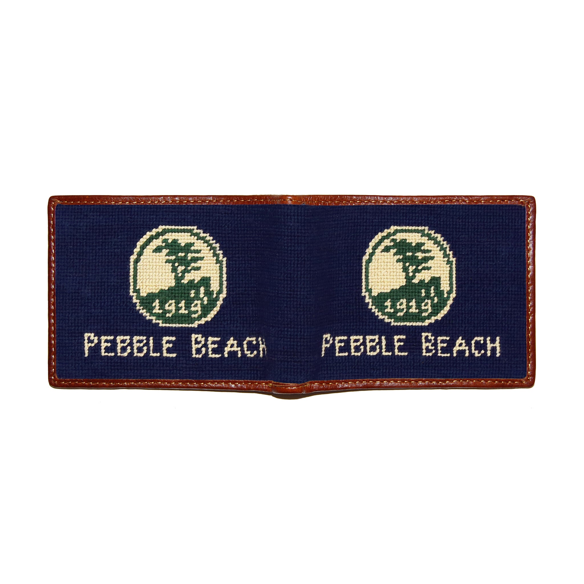 Pebble Beach logo needlepoint bi-fold wallet in dark navy with chestnut leather trim, shown from secondary angle showing interior needlepoint.