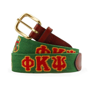 Phi Kappa Psi Needlepoint Belt coiled, with brown leather trim and a brass buckle