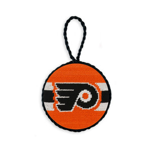 Orange needlepoint ornament featuring Philadelphia Flyers jersey stripes and logo, finished with a black hanging cord.