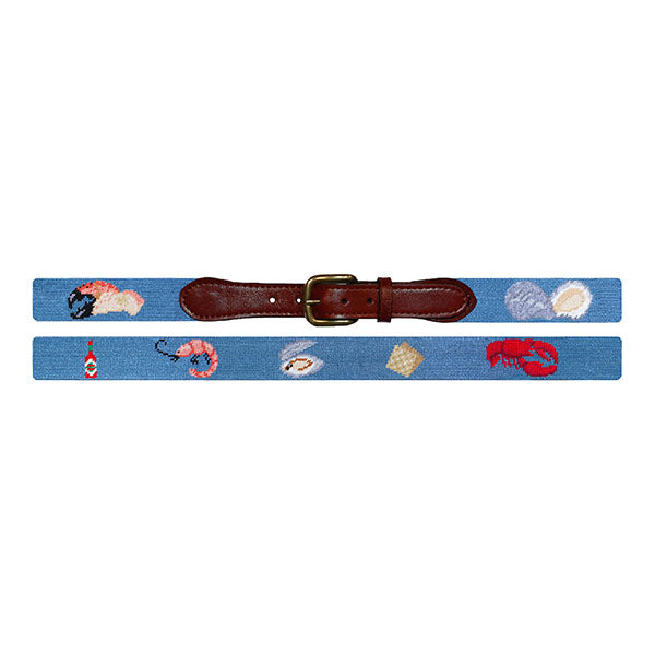 Needlepoint belt with marine-themed designs on a white background