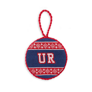 Navy needlepoint ornament featuring the red Richmond spider logo, finished with a white hanging cord.