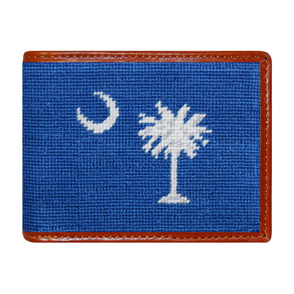 Blueberry needlepoint bi-fold wallet with South Carolina flag design, brown leather trim, shown from primary angle.