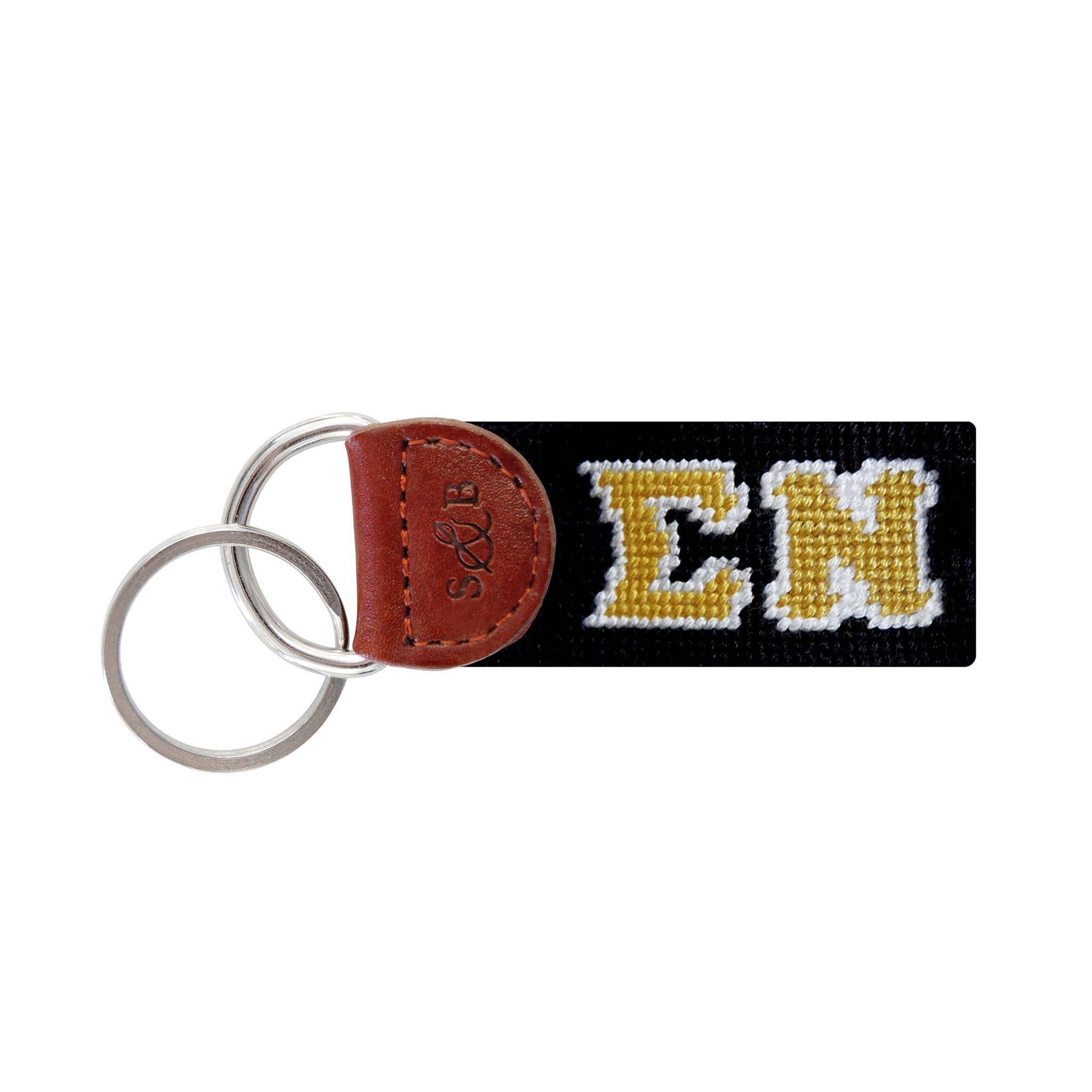 Black needlepoint key fob with the Greek letters ΣΝ in white, brown leather trim, and a metal key ring.