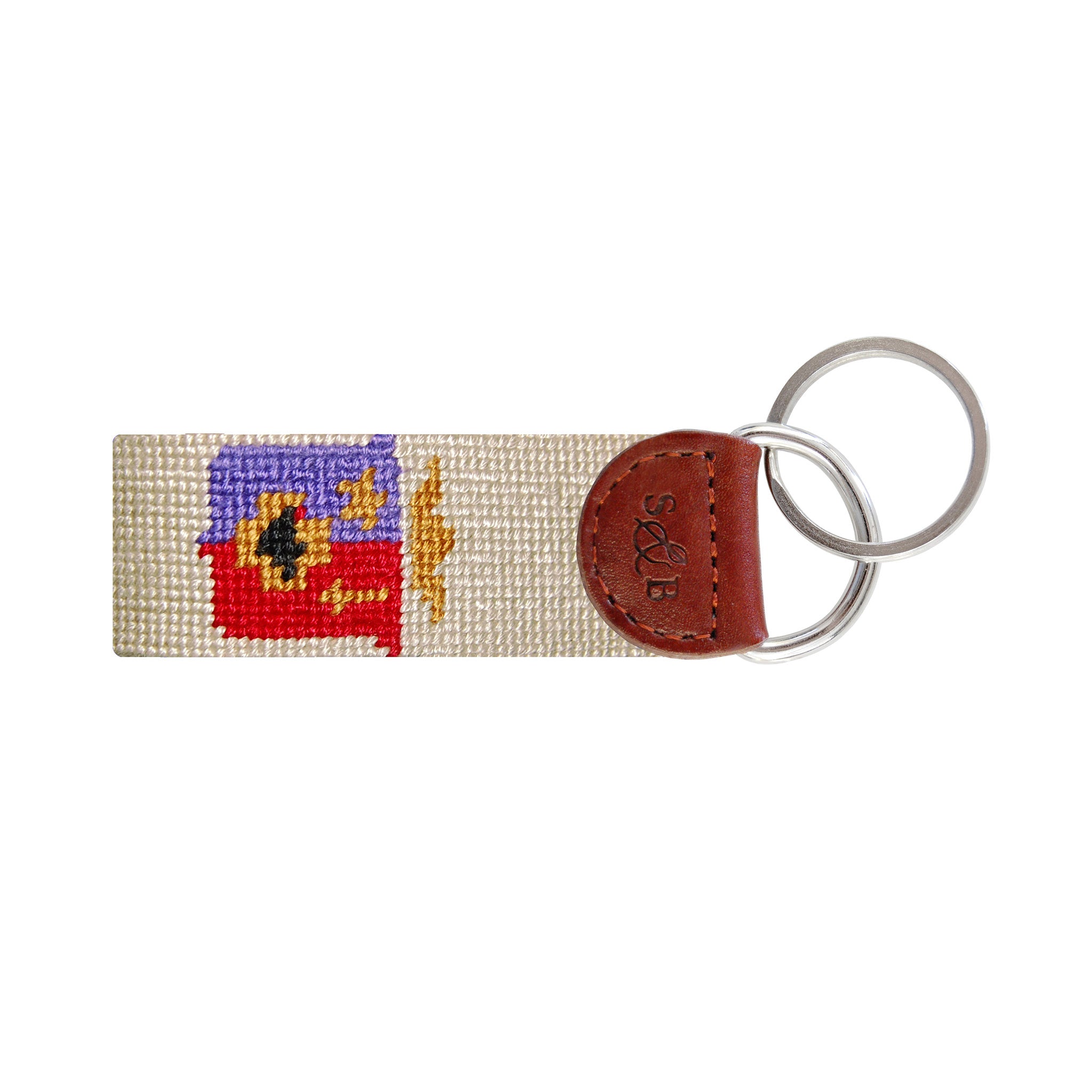 Navy needlepoint key fob with the crest of ΣΦΕ in gold and red, brown leather trim, and a metal key ring.