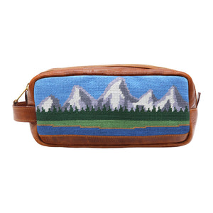 Multi-colored needlepoint toiletry bag featuring the Tetons design with full grain Italian leather trim.
