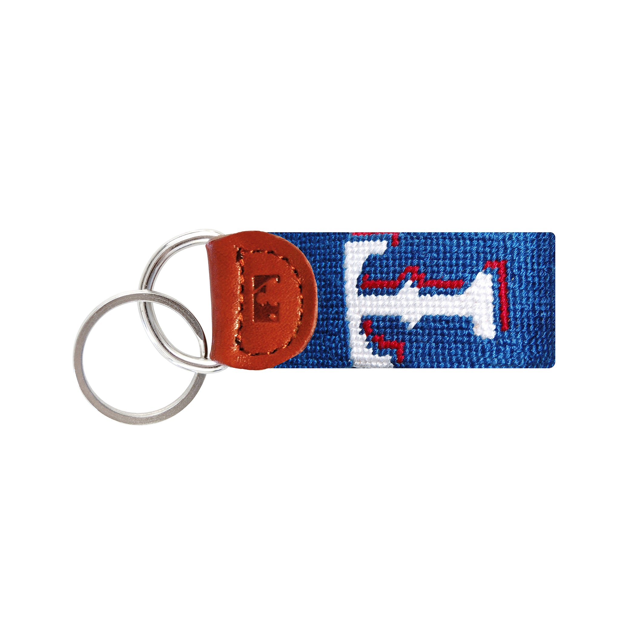 Dark navy needlepoint key fob featuring the red, white, and blue Texas Rangers “T” logo, brown leather trim, and a metal key ring.
