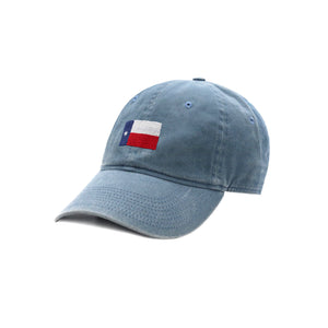 Six-panel cotton hat in steel blue featuring the Texas flag stitched in red, white, and blue thread on the front.