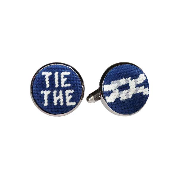 Tie the Knot cufflinks featuring a classic navy needlepoint design with stitched white text, set into a silver-plated cufflink.