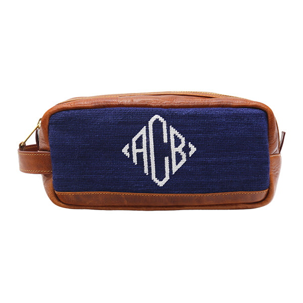 Black toiletry bag with diamond monogram pattern and full grain Italian leather trim.